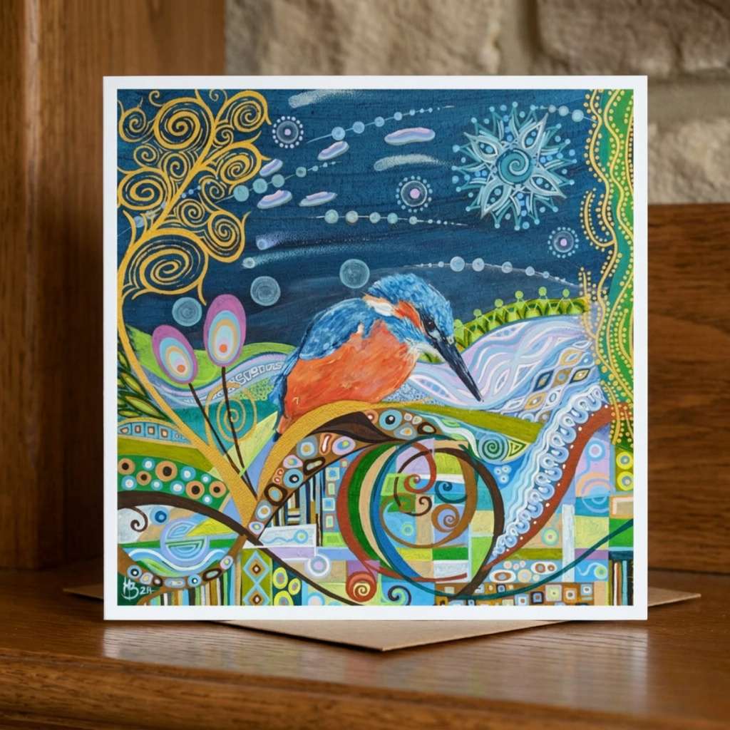 Colourful greeting card with a kingfisher design on a wooden surface