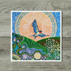 Colourful artwork of a bird flying over a landscape with flowers on a wooden surface