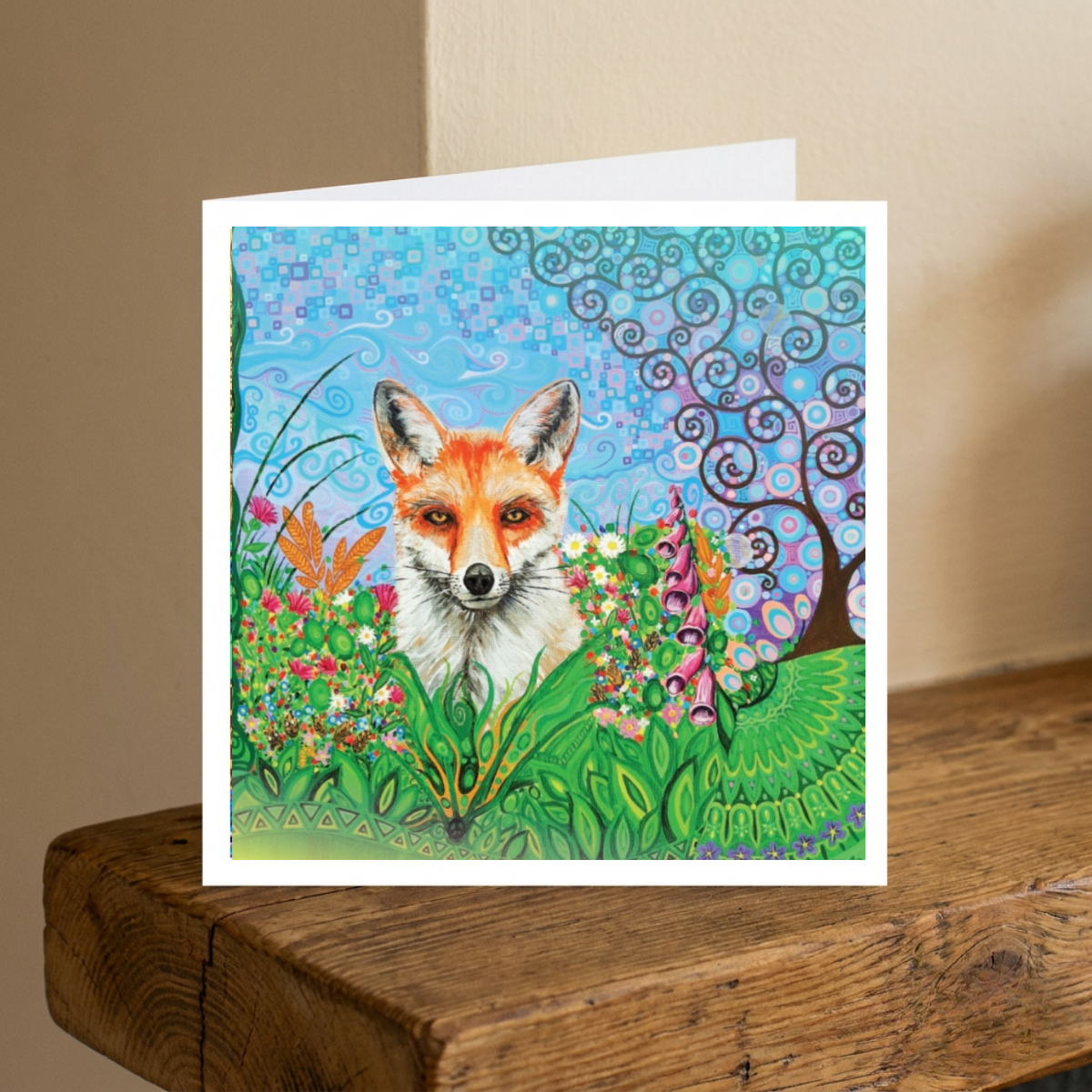 Greeting card with a colourful illustration of a fox in a garden on a wooden surface.