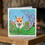 Greeting card with a fox illustration on a wooden surface