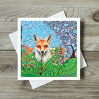 Colourful greeting card with a fox illustration on a wooden surface