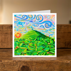 Colourful abstract landscape with green hills and blue sky of the Glastonbury Tor in Somerset on a wooden surface