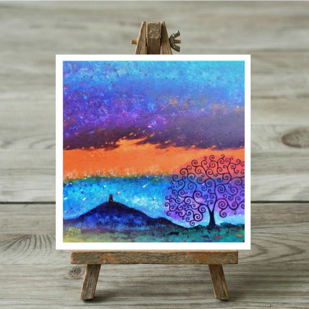 Colourful abstract painting on a wooden easel against a wooden background of Glastonbury Tor