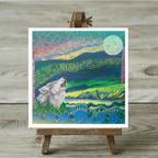 Colourful artwork of a wolf howling at the moon on a wooden easel against a wooden background