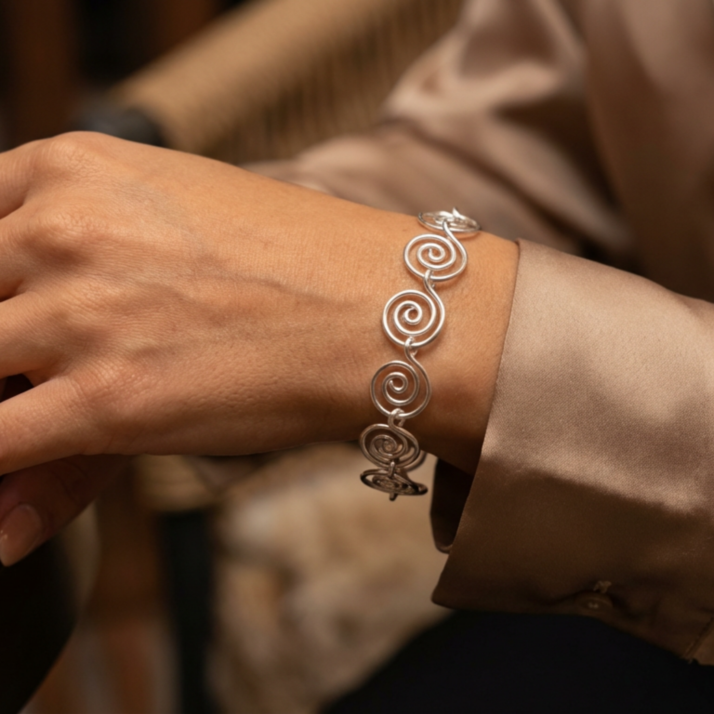 Model wearing a silver spiral bracelet