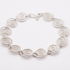 Silver spiral bracelet with a white background