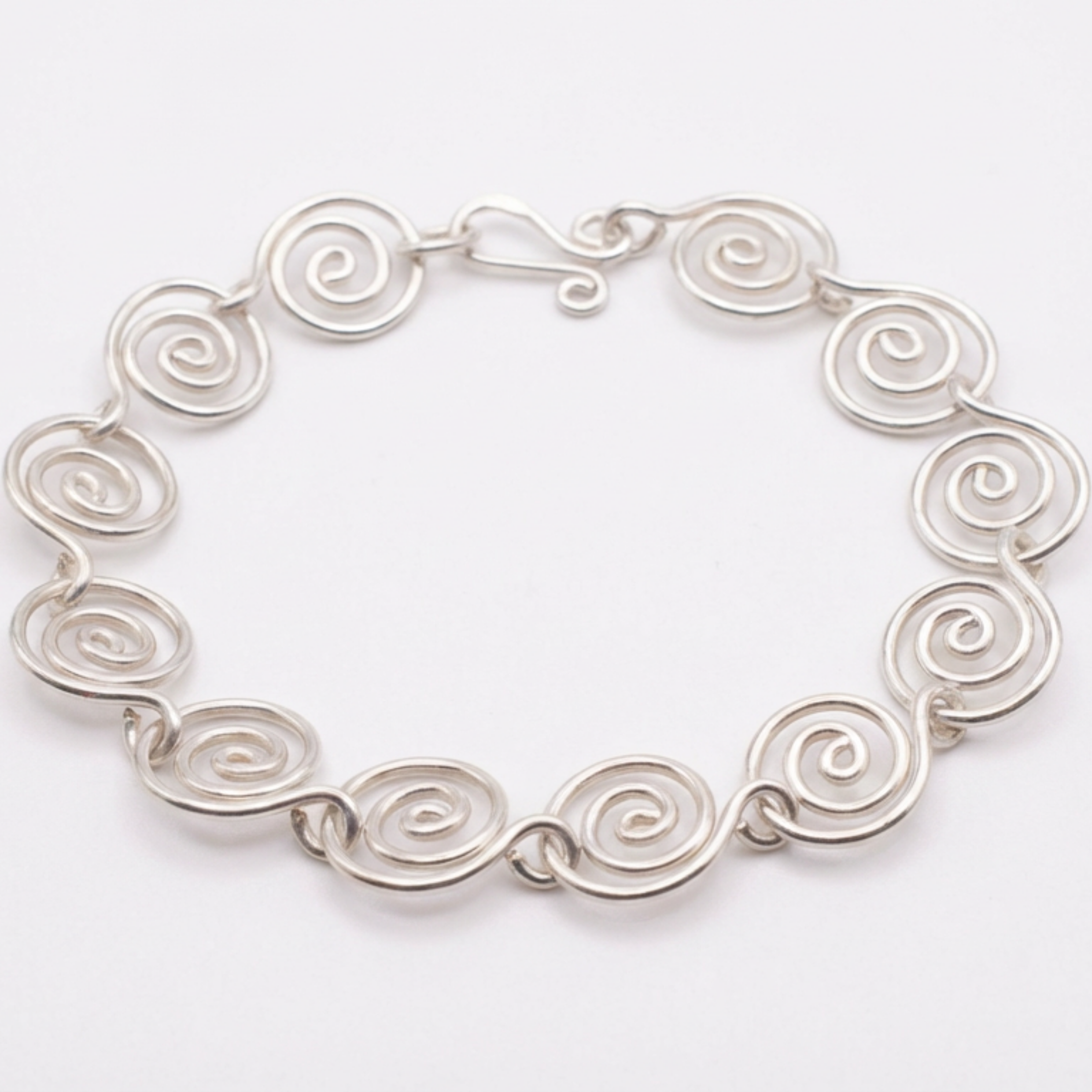 Silver spiral bracelet with a white background