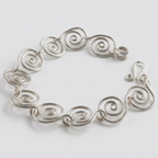 Detailed view of a silver spiral bracelet