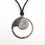 Necklace with a circular pendant featuring a spiral design on a white background
