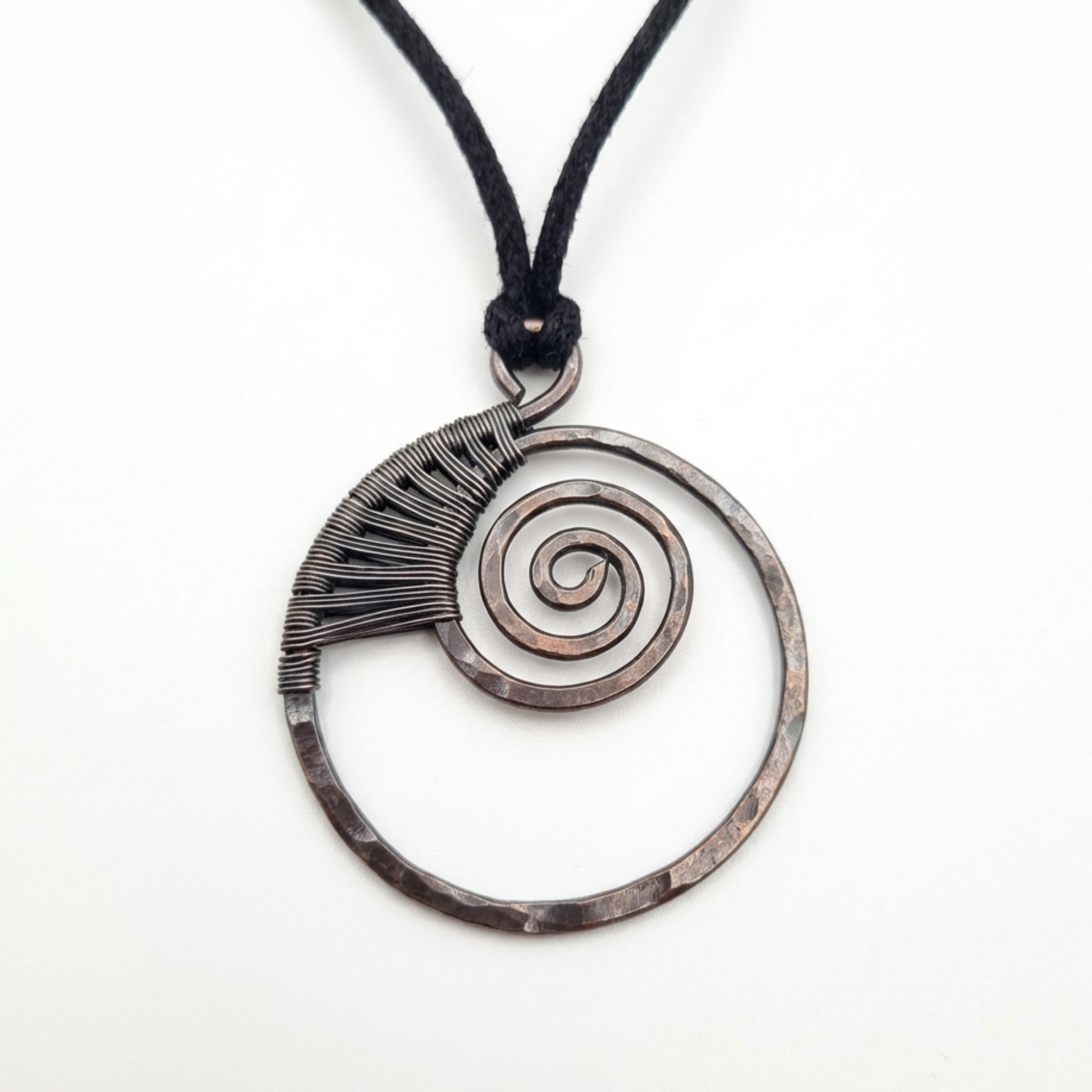Necklace with a circular pendant featuring a spiral design on a white background
