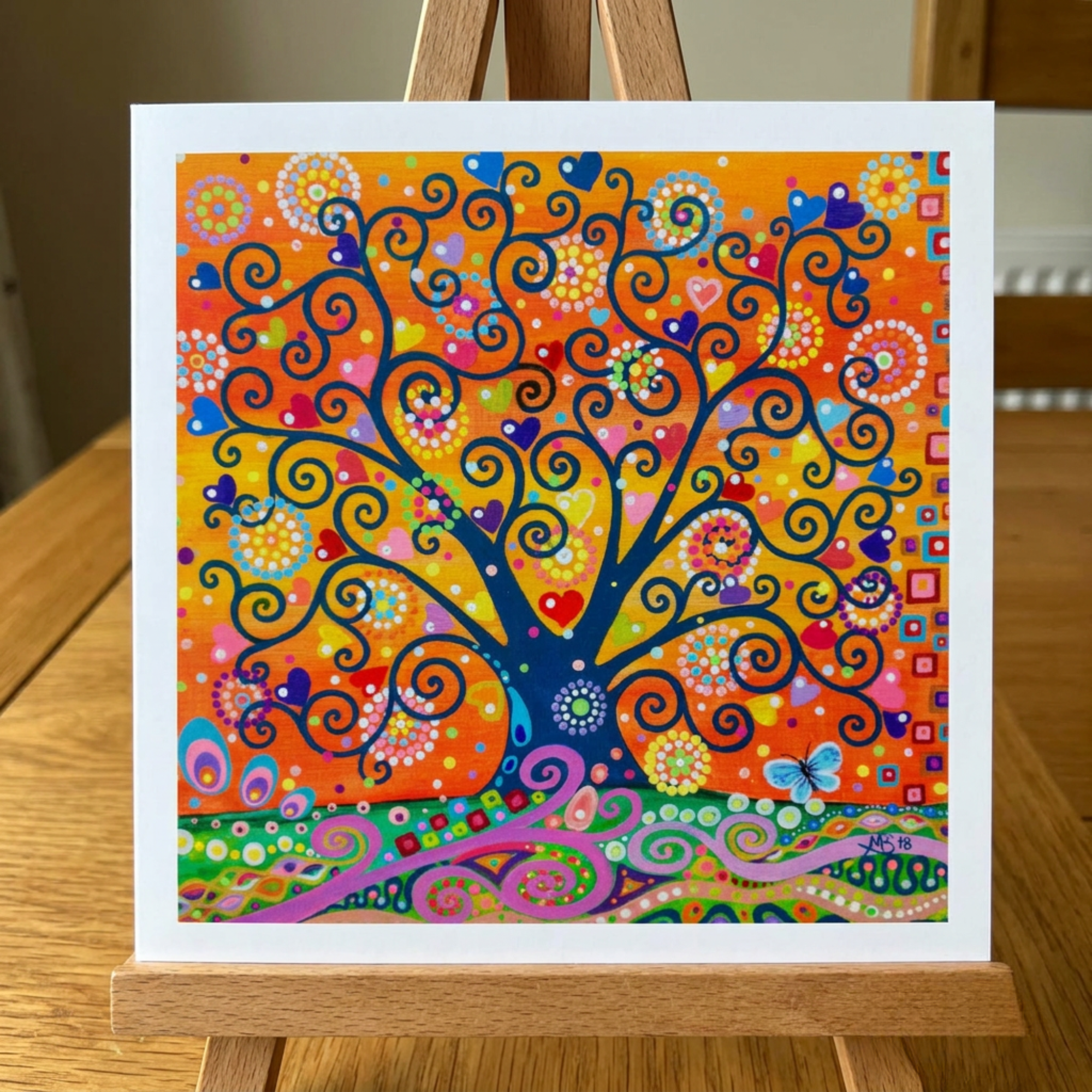 Colourful abstract tree artwork on a wooden easel