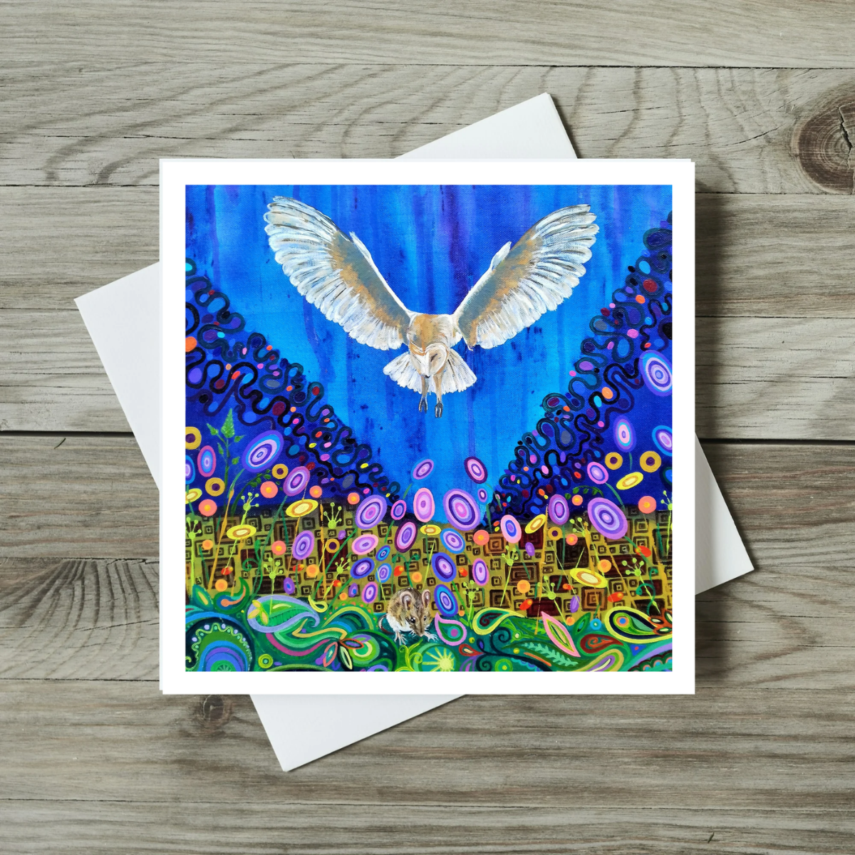 Colourful greeting card with a bird design on a wooden surface