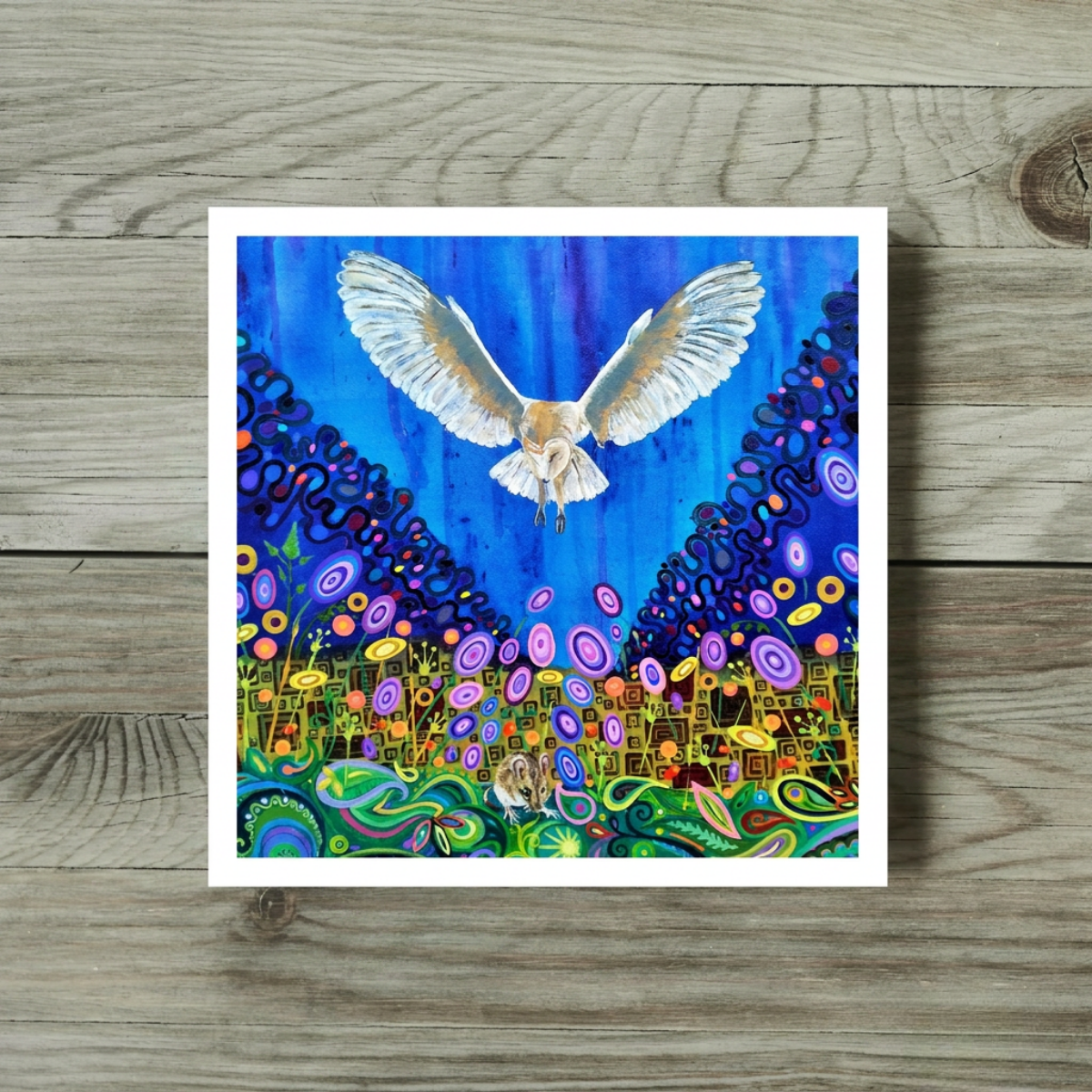 Colourful artwork of a barn owl bird flying over a vibrant, abstract landscape hiding a mouse on a wooden surface.