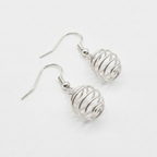 Silver wire-wrapped earrings on a white background