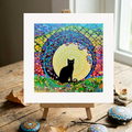 Colourful abstract artwork with a black cat silhouette on a wooden surface.