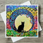 Colourful card with a black cat silhouette in a mandala design on a wooden surface.