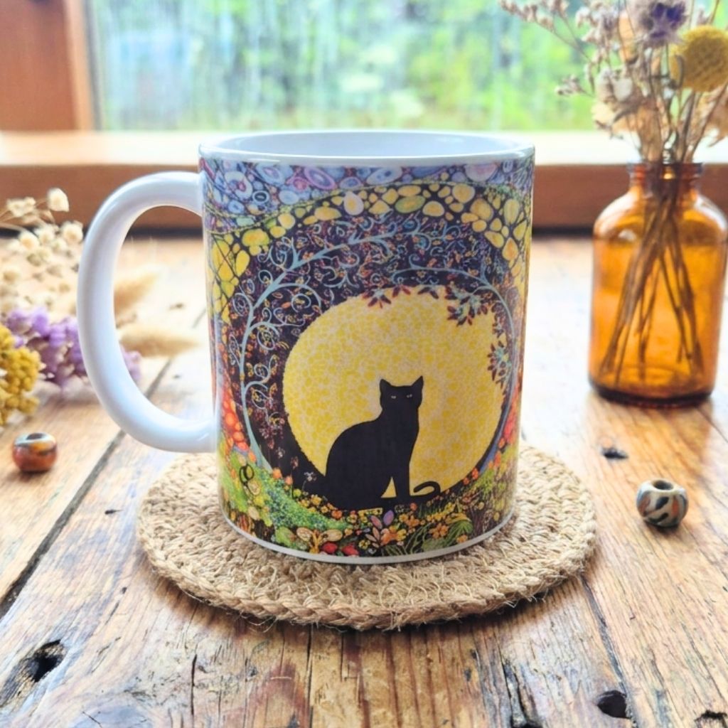 Mug with a cat design on a wooden table with a natural background
