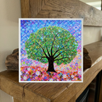 Colourful abstract tree of life artwork on a wooden surface