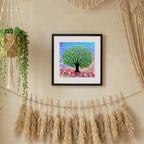 Framed artwork of a colourful tree on a wall with decorative elements