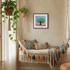 Decorative indoor swing with colourful pillows and a framed artwork on the wall.
