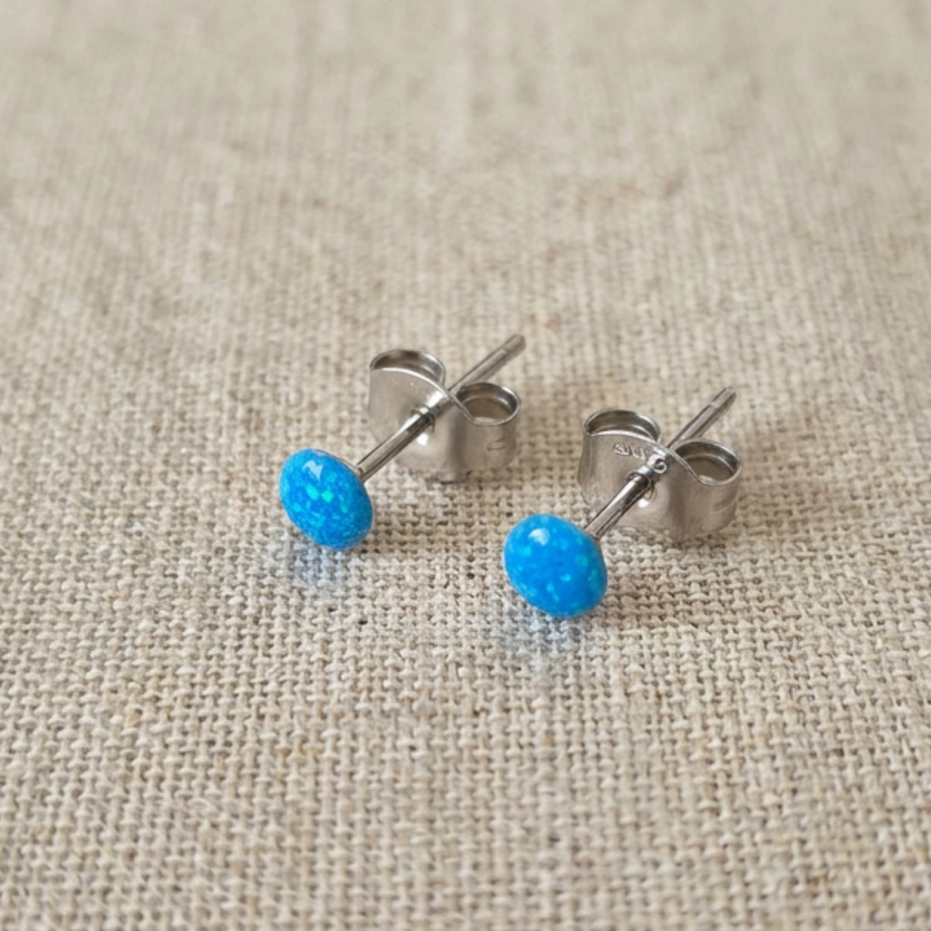Resin stud earrings on a fabric cloth