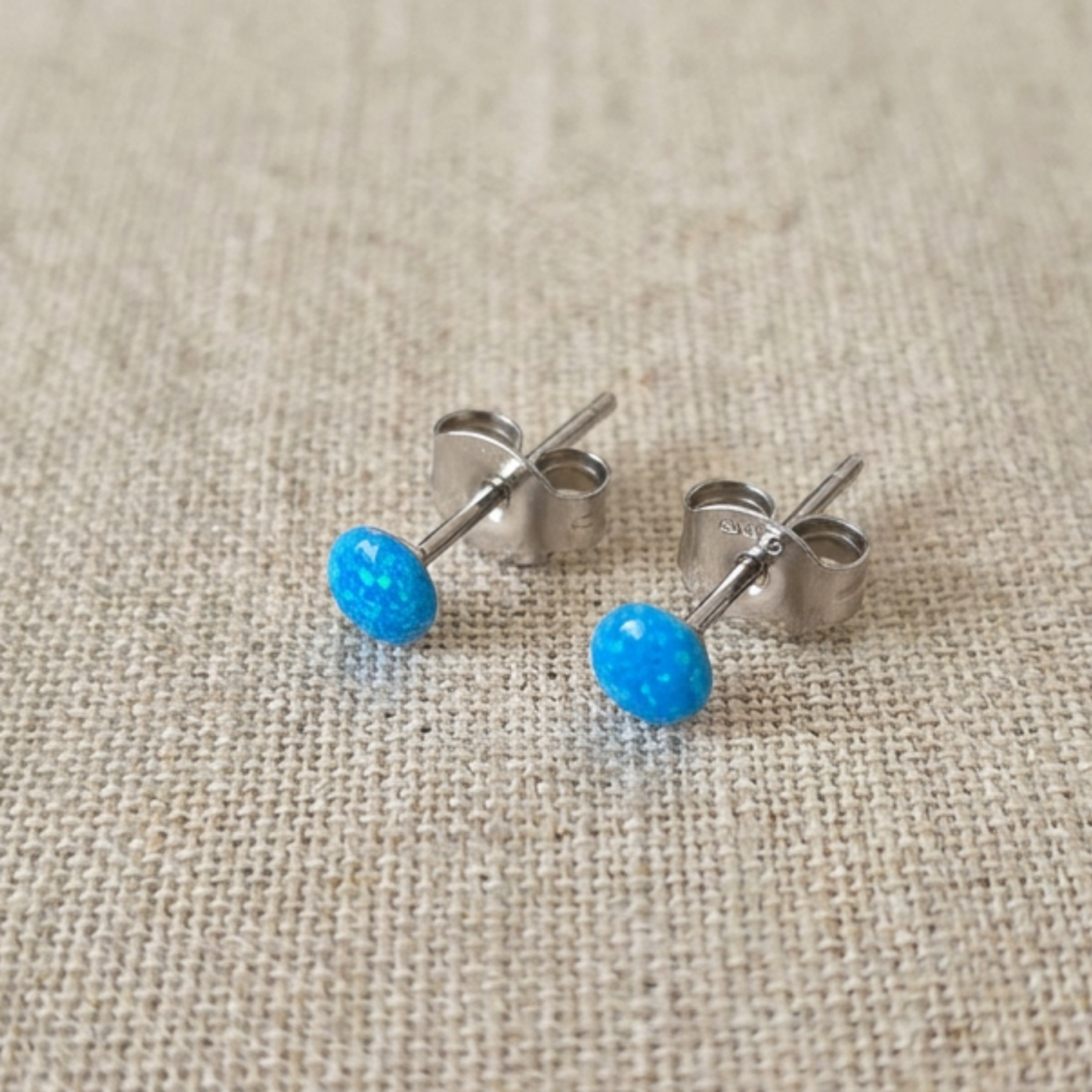Resin stud earrings on a fabric cloth