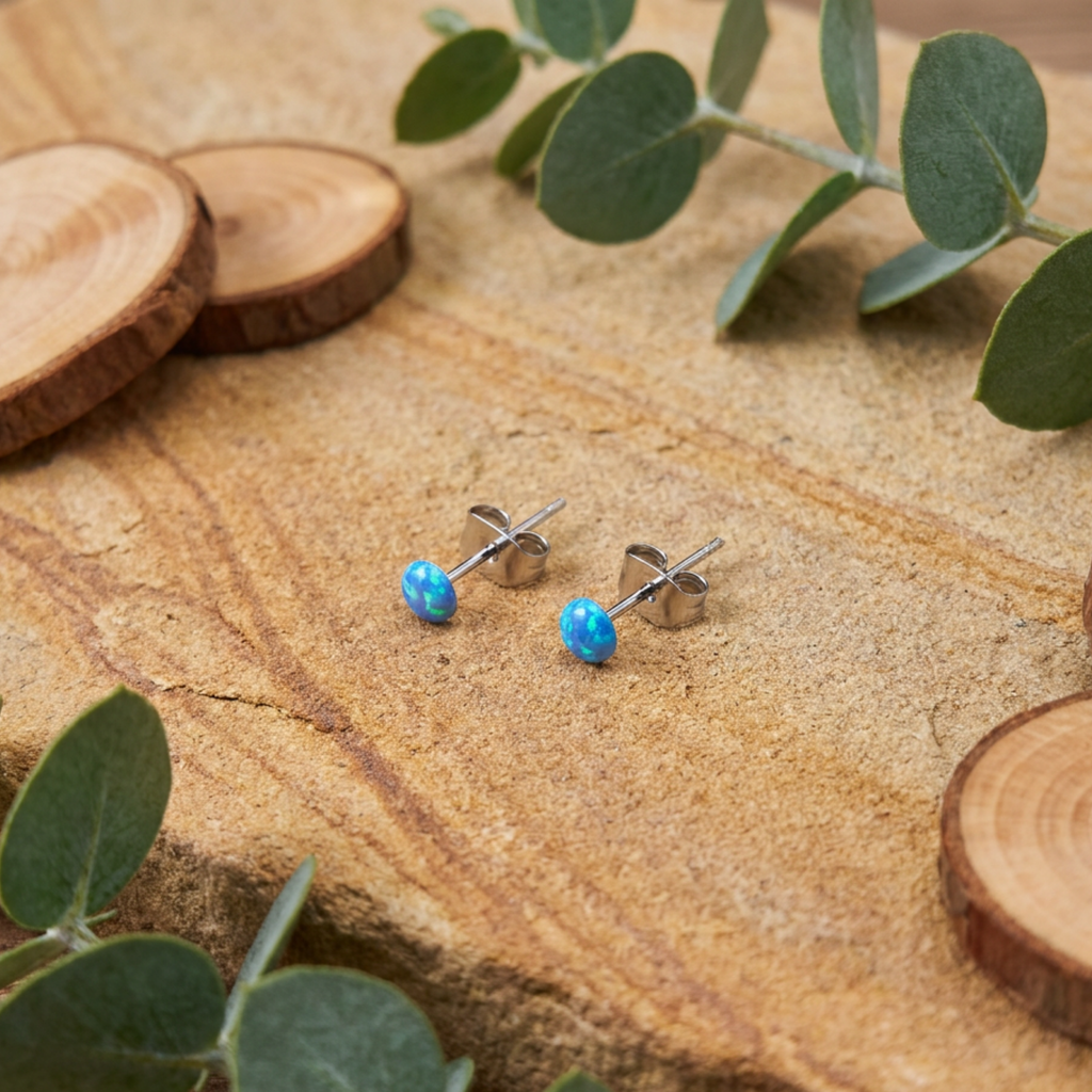 Blue spot stud earrings on a rustic backdrop