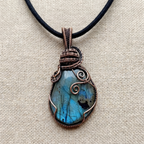 Necklace with a blue stone pendant on a beige fabric background