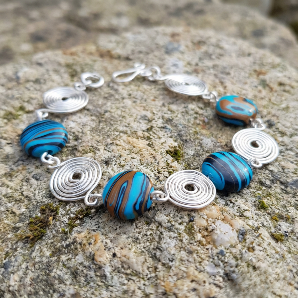 Bracelet with blue and brown beads on a textured stone surface