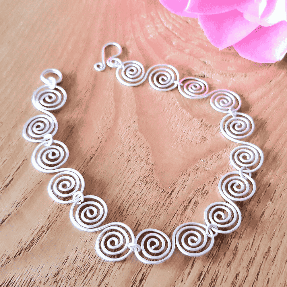 Silver spiral Celtic bracelet on a wood back drop