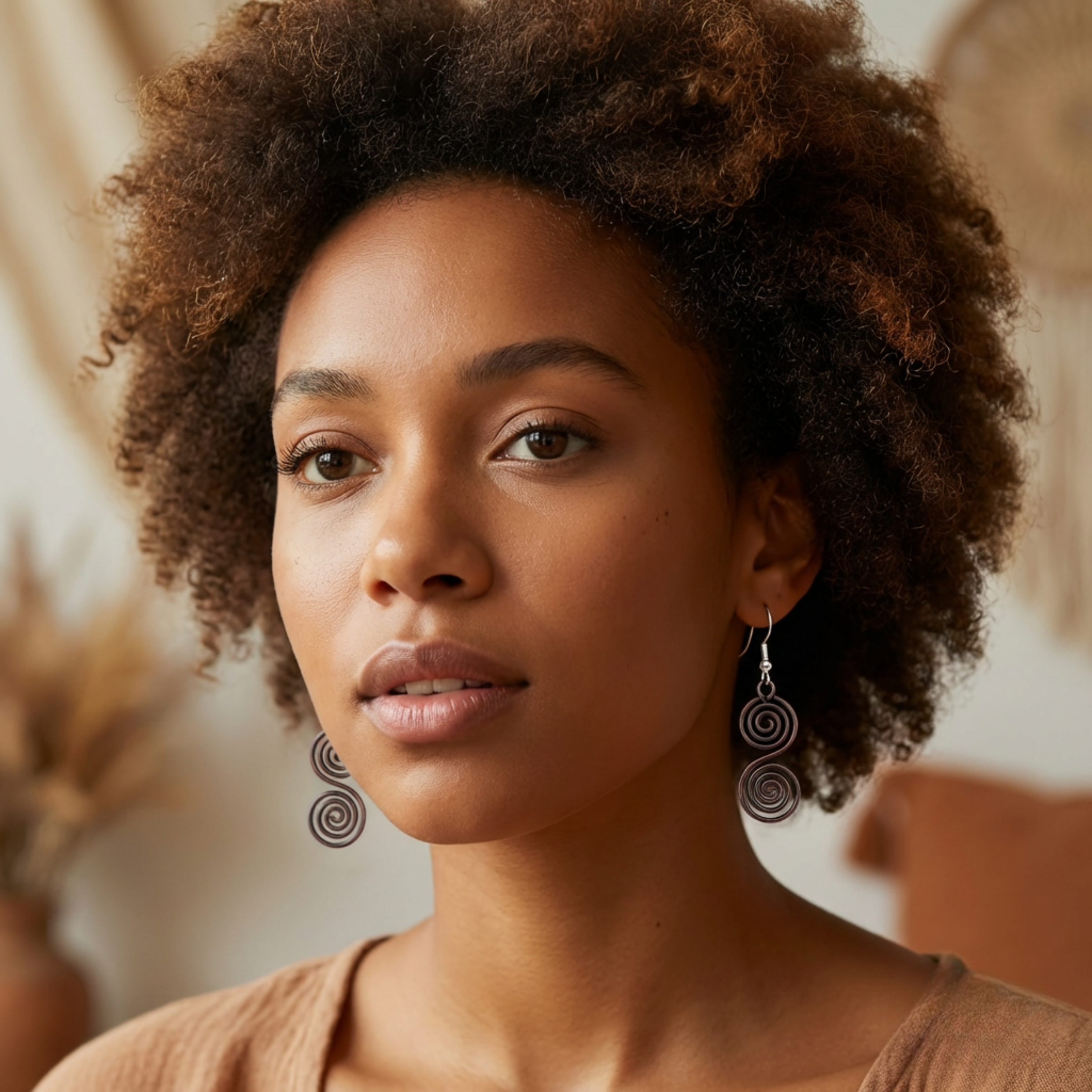 Model wearing S shaped copper Celtic spiral earrings