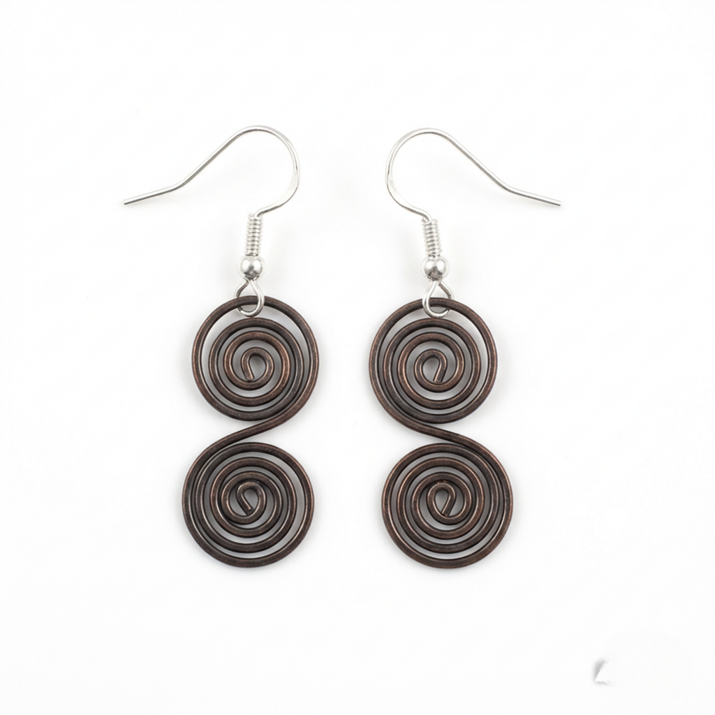 Celtic copper spiral earrings flat lay, handmade boho drop earrings UK