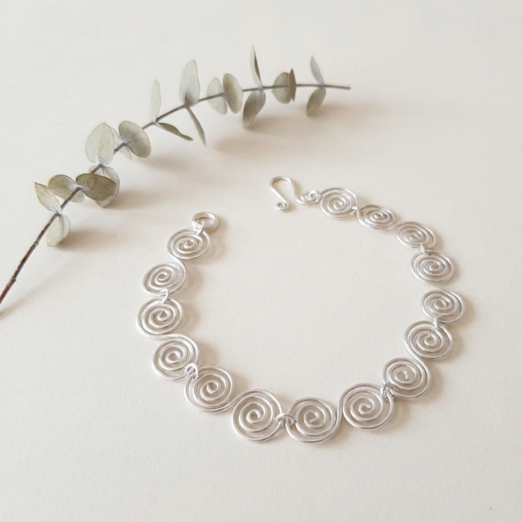 Celtic silver spiral bracelet on a white surface