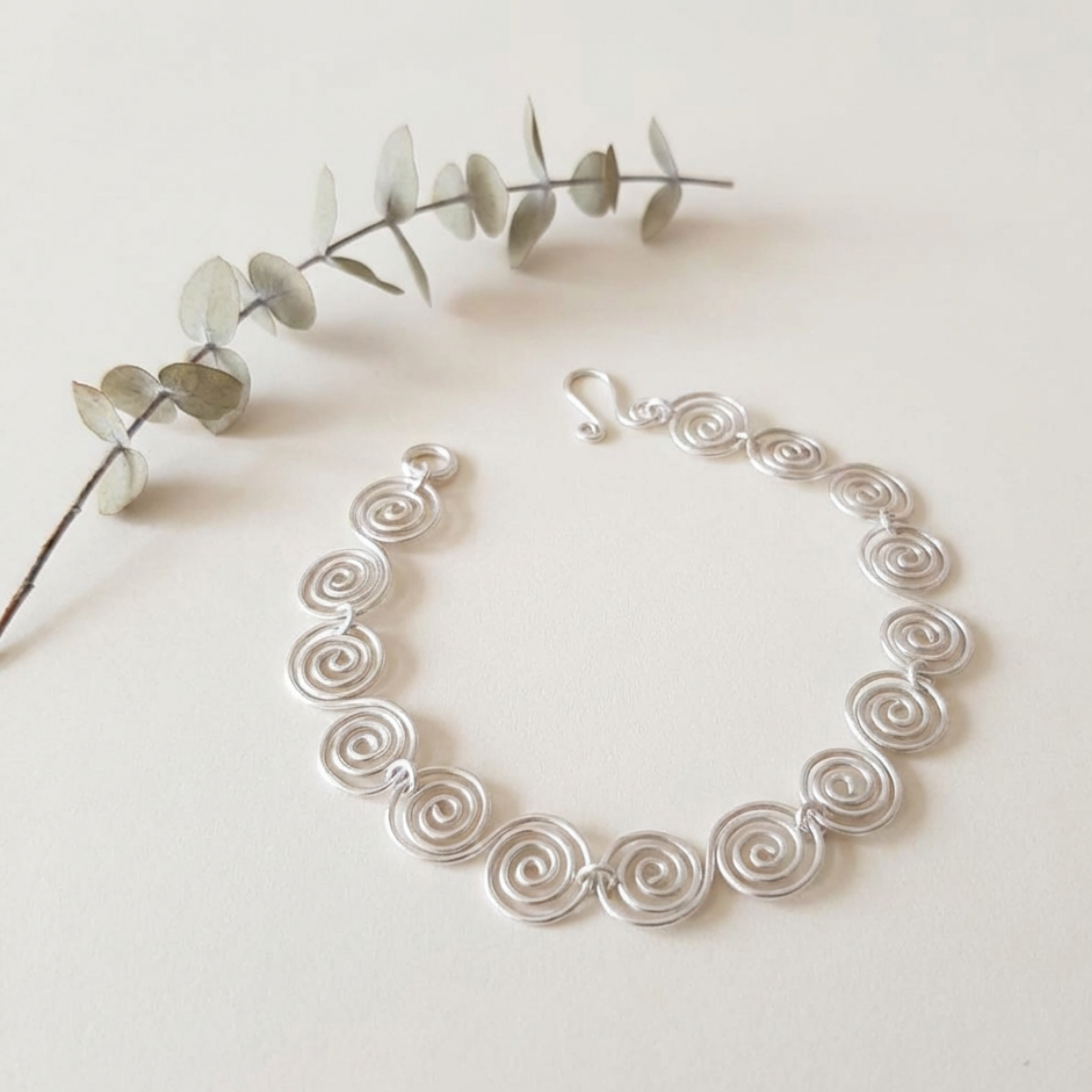 Celtic silver spiral bracelet on a white surface
