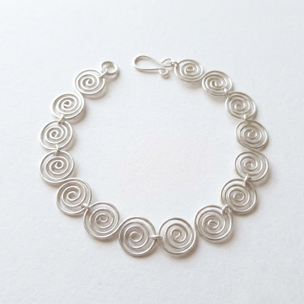 Celtic silver spiral necklace on a white back drop