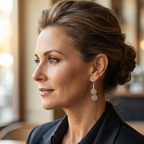 Woman wearing a black blazer with a blurred indoor background and a pair of Celtic silver spiral earrings