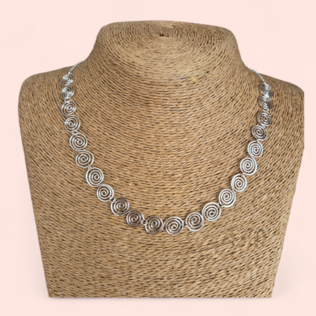 Straw mannequin wearing a Celtic Silver Spiral Necklace