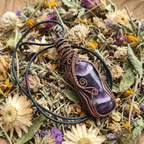Amethyst pendant necklace on a bed of dried flowers