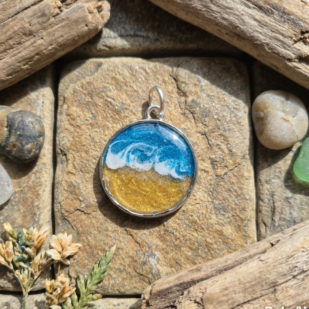 Round pendant with ocean design on a stone surface