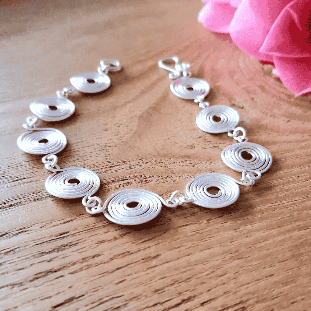 side view of the silver spiral bracelet showing the thickness of the wire