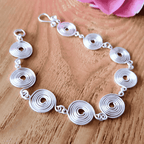 Silver spiral bracelet showing the simple fish hook clasp