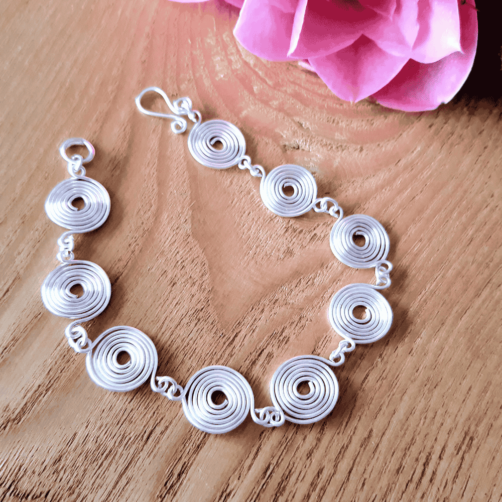 Overhead view of a silver spiral bracelet