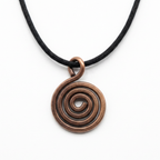 Copper spiral pendant on a black cord against a white background