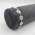 Jeweller display showing a silver spiral bracelet