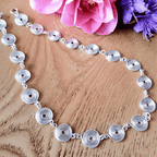 Detailed full view of a silver spiral necklace