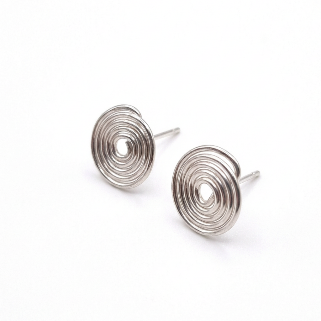 Pair of silver spiral earrings on a white background