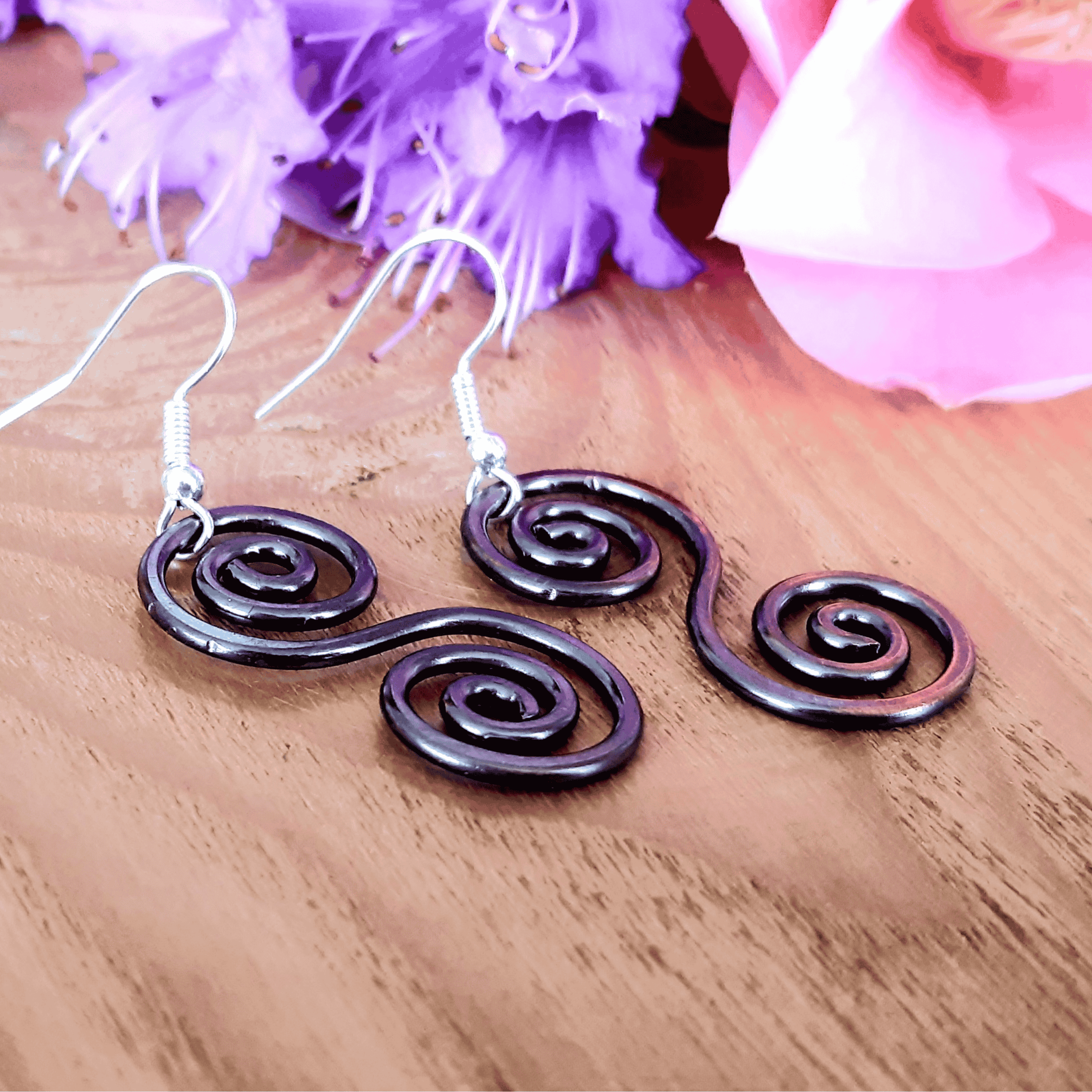 Boho copper Celtic earrings on a wooden surface
