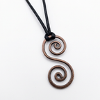Copper spiral pendant on a black cord against a white background