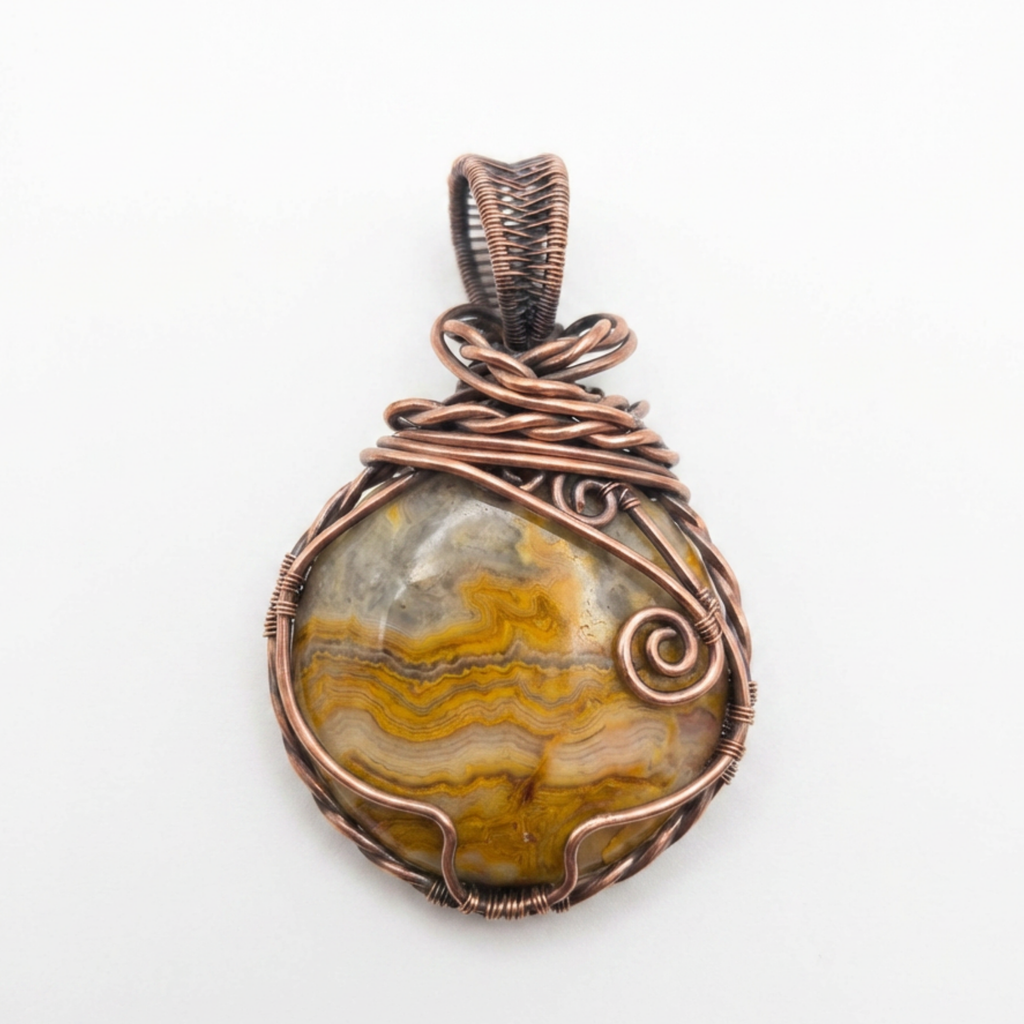 Copper-wrapped pendant with a stone on a white background