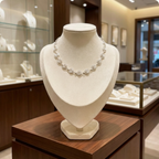 Silver spiral necklace on a mannequin bust in a jewellery store setting